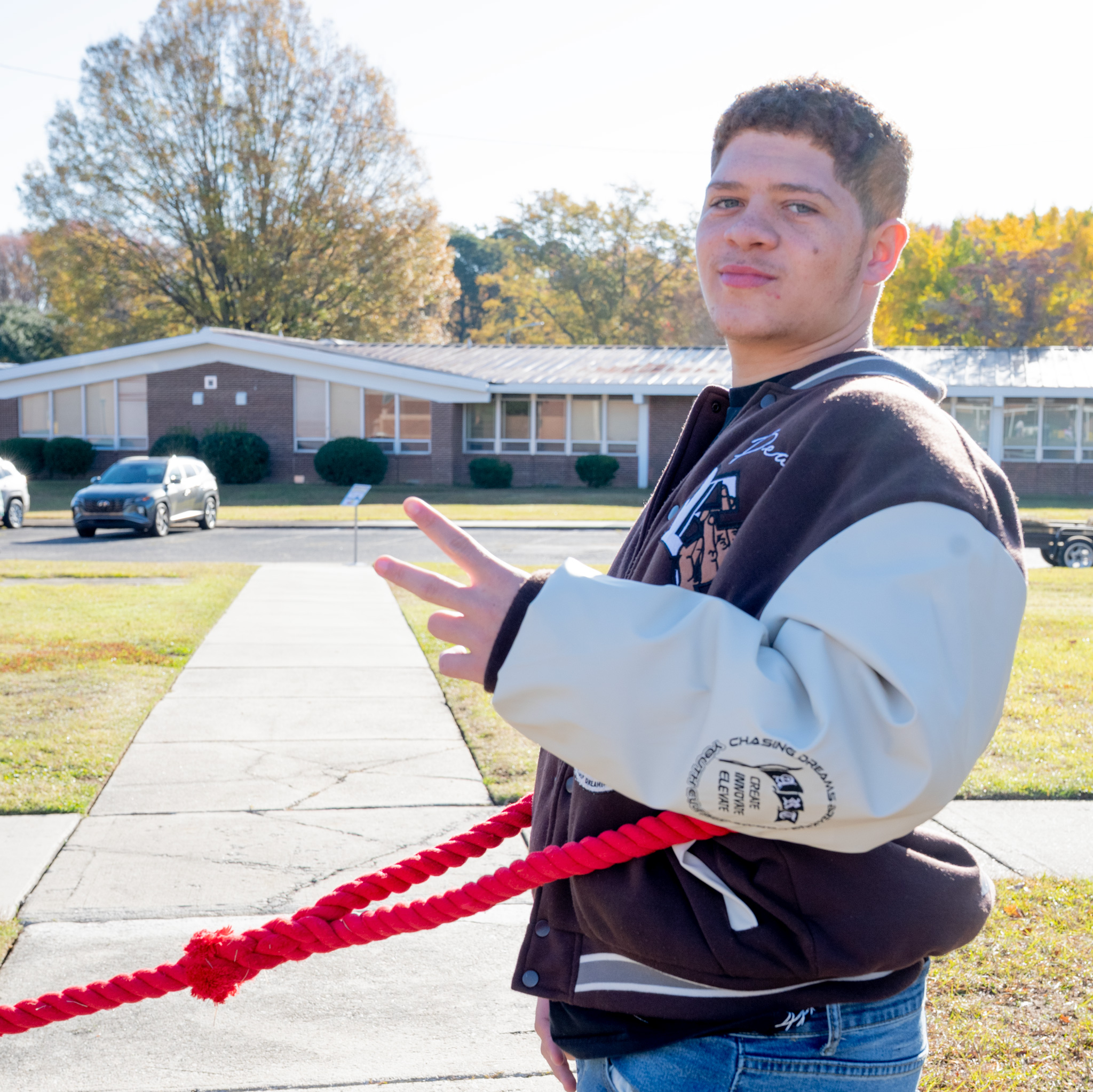 Fall Fest: Student anchored on a red rope for tug-of-war