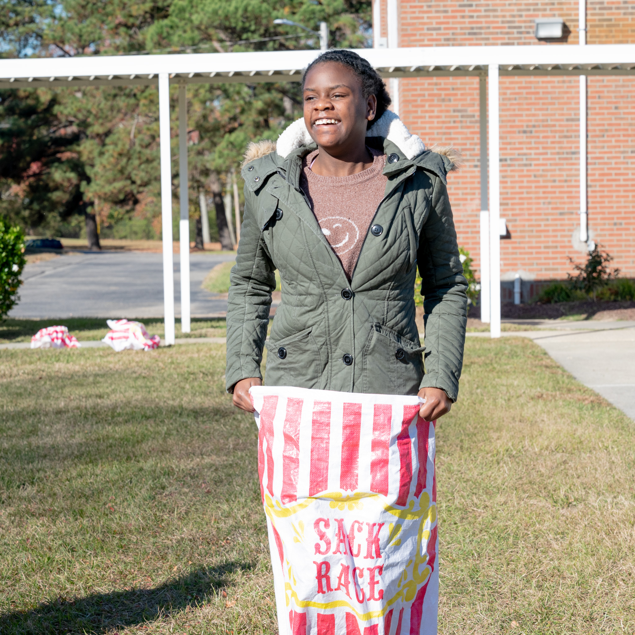 Fall Fest: Student in hopping in sack race.