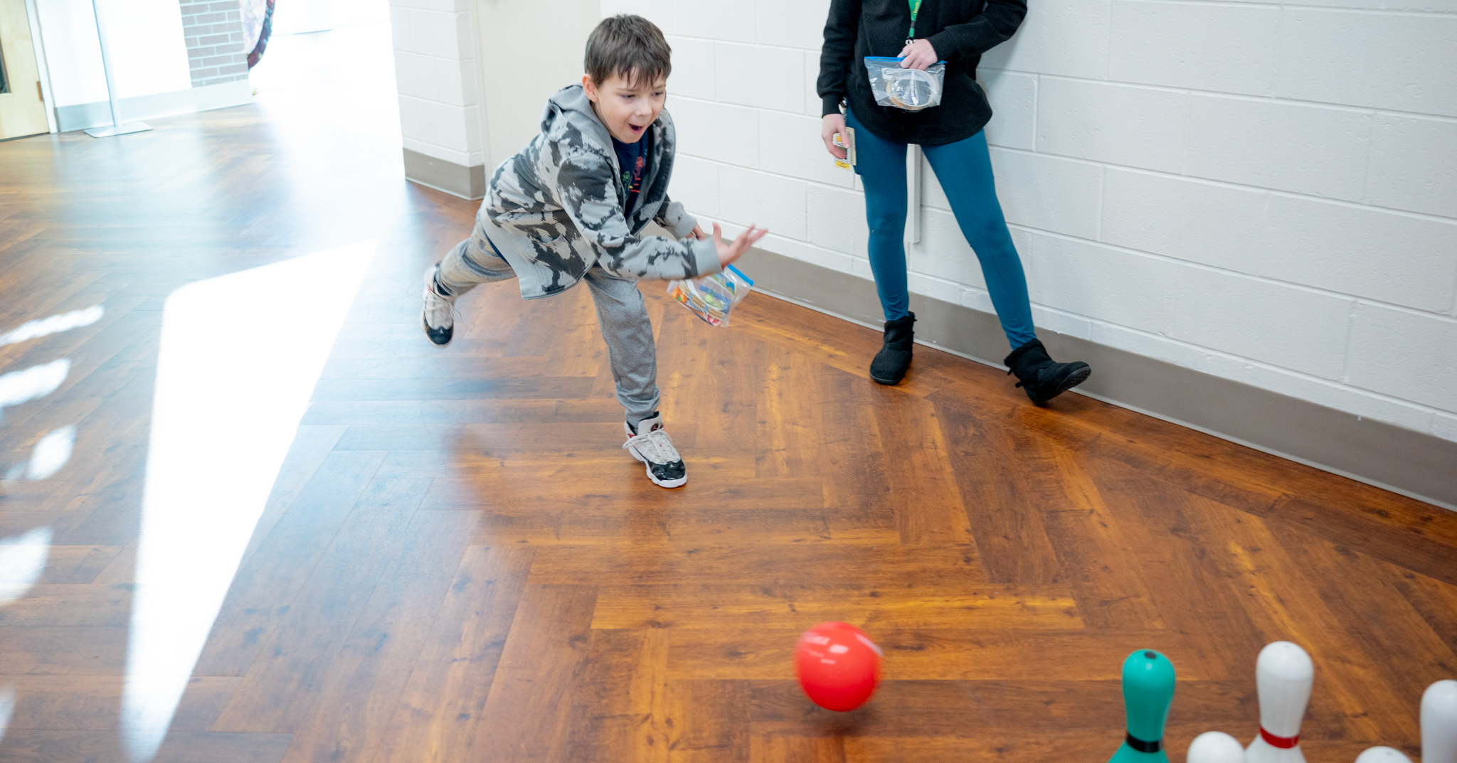 Fall Fest: Student bowling with plastic ball.