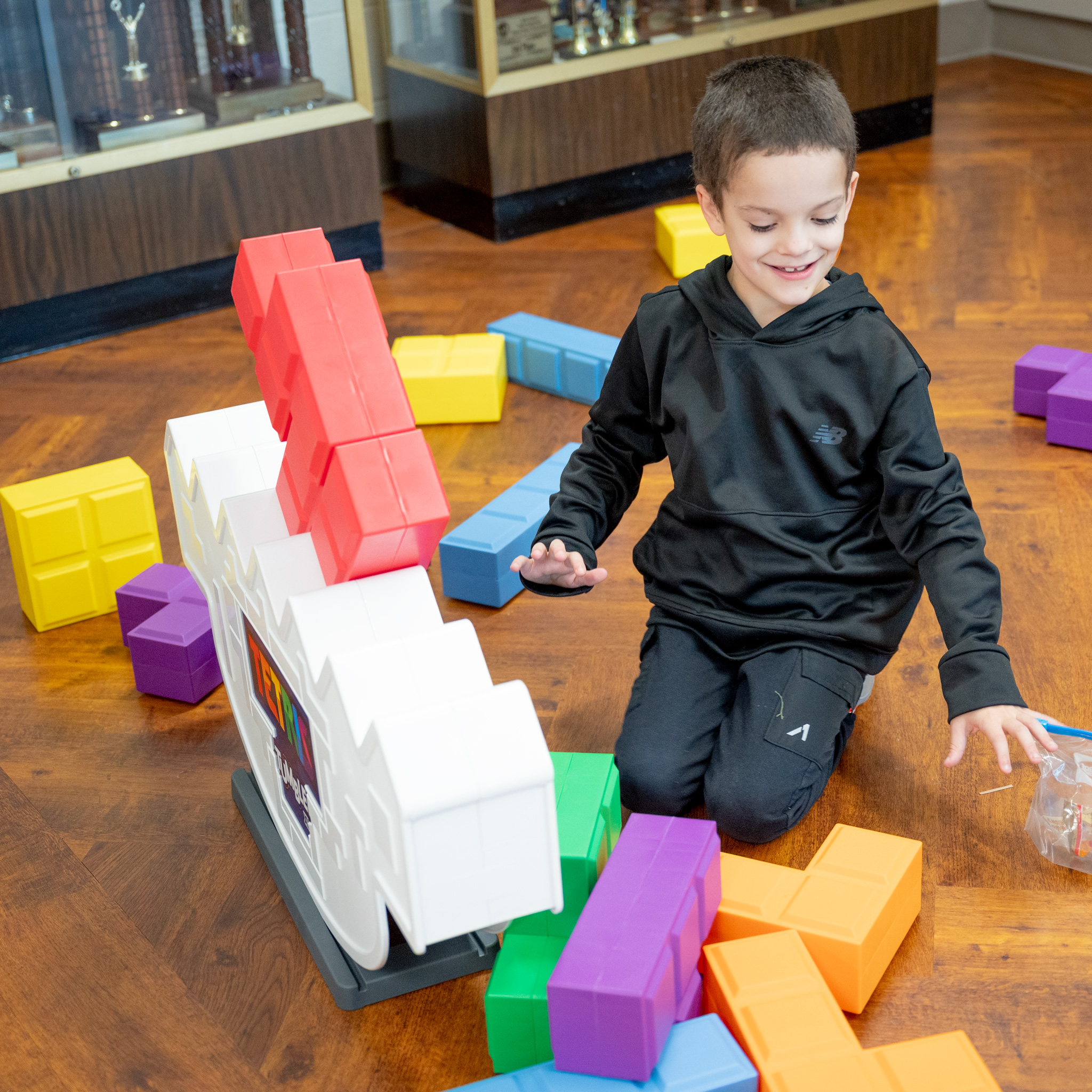 Fall Fest: elementary student playing with large plastic Tetris blocks