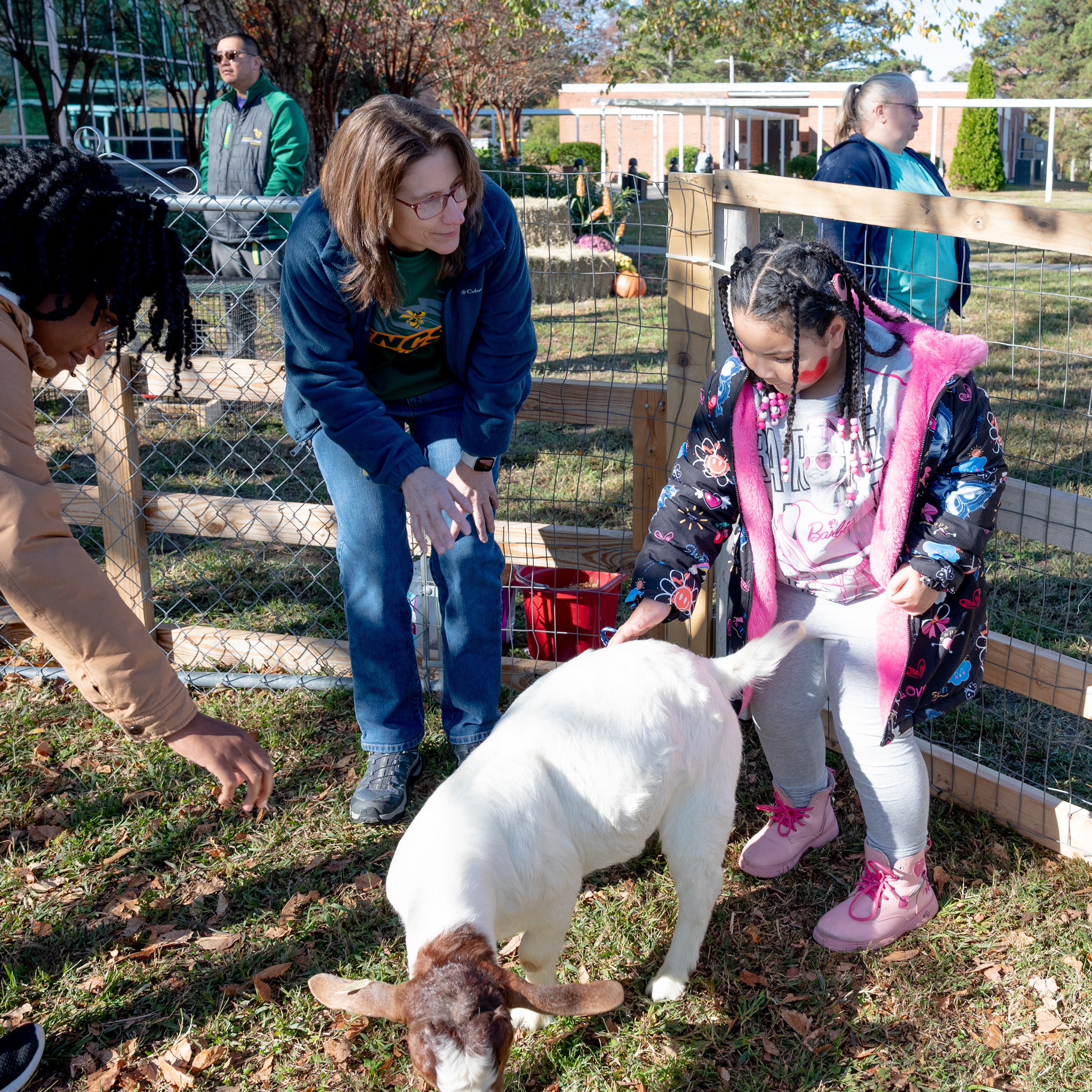 Fall Fest: Brenda with an elementary student as she pets a goat