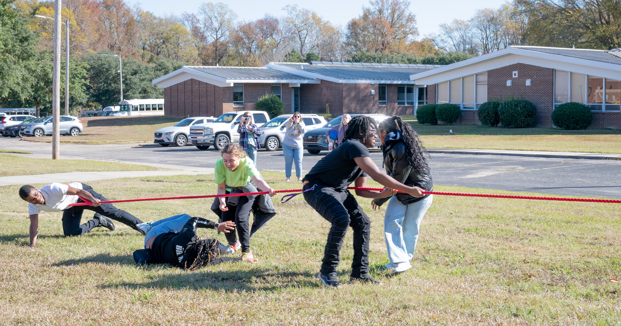 Fall Fest: 5 students on the other side of the tug-of-war falling over as they lose