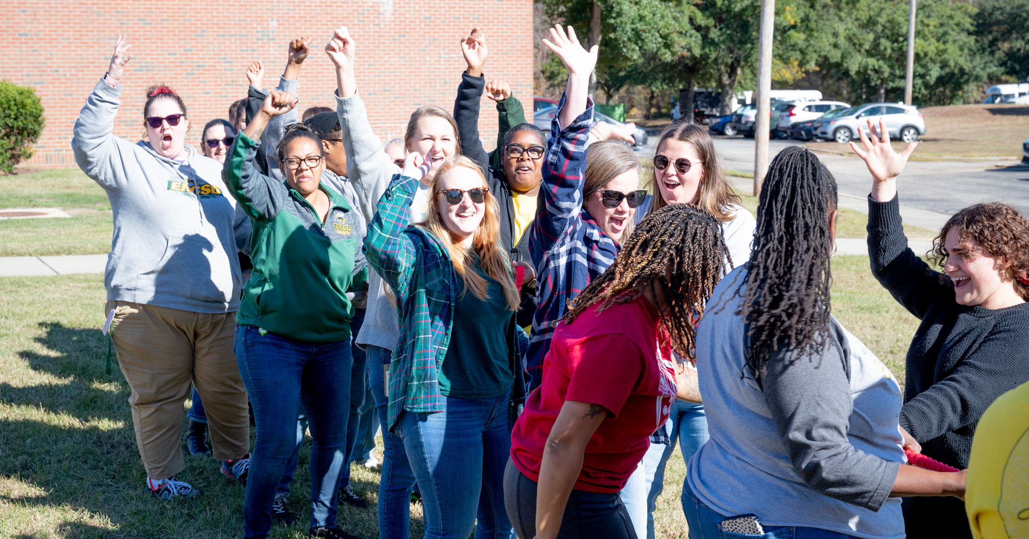 Fall Fest: Women staff members celebrating their win agains the men in tug-of-war